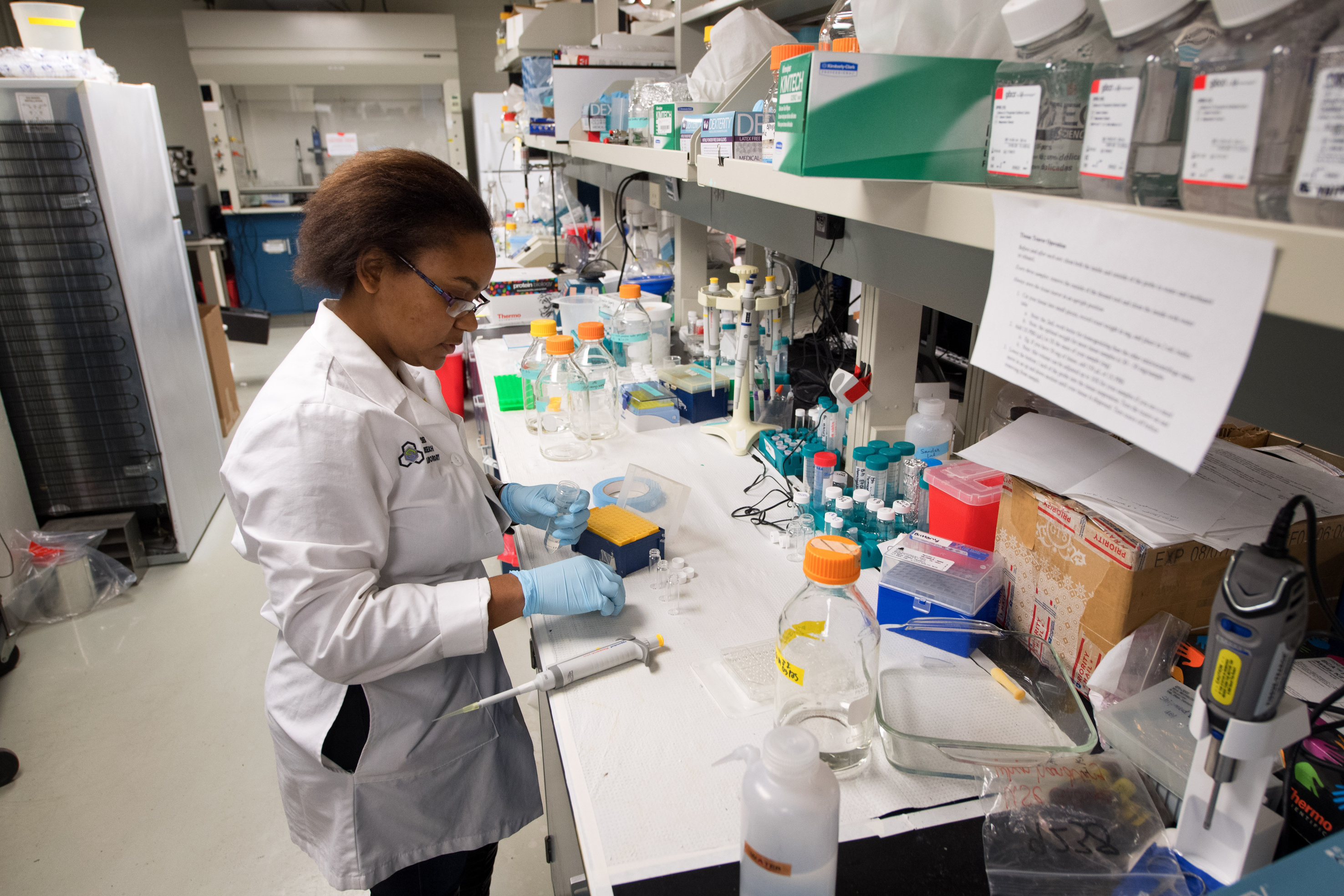 Dr. Aliasger K. Salem  working in his lab alongside student technicians.