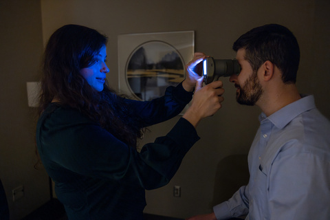 Woman scanning eye of man