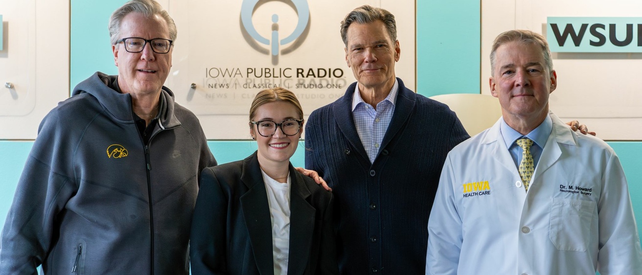 Group of people in front of Iowa Public Radio backdrop