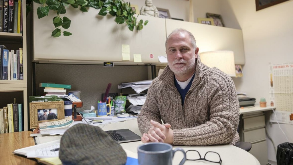 University of Iowa Associate Professor of Classics and Biblical Studies Robert Cargill sits for a portrait Dec. 6 in his office in Iowa City