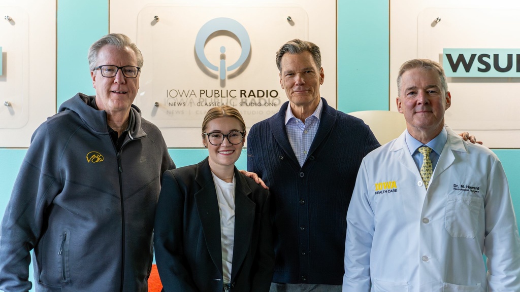 Group of people in front of Iowa Public Radio backdrop
